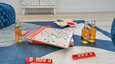 a table with bottles of beer and a boardgame at Joyful Sound by AvantStay Walk to the Beach in Panama City Beach