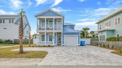 a house with a blue and white at Joyful Sound by AvantStay Walk to the Beach in Panama City Beach