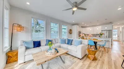 a living room with a couch and a table at Joyful Sound by AvantStay Walk to the Beach in Panama City Beach