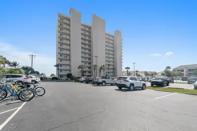 a parking lot with cars parked in front of a building at BeachCrest 101 - Directly on the beach in the heart of Seagrove Beach along 30A in Santa Rosa Beach