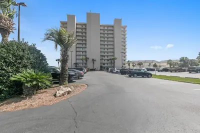 a parking lot with cars parked in front of a building at BeachCrest 101 - Directly on the beach in the heart of Seagrove Beach along 30A in Santa Rosa Beach