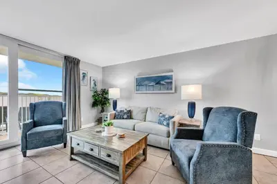 a living room with a couch and two chairs at BeachCrest 101 - Directly on the beach in the heart of Seagrove Beach along 30A in Santa Rosa Beach