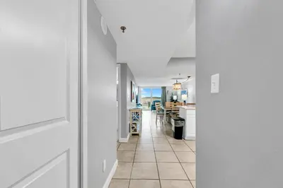 a hallway leading to a kitchen and a dining room at BeachCrest 101 - Directly on the beach in the heart of Seagrove Beach along 30A in Santa Rosa Beach