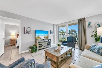 a living room with a couch and a table at BeachCrest 101 - Directly on the beach in the heart of Seagrove Beach along 30A in Santa Rosa Beach