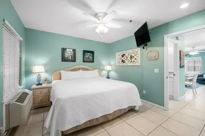 a bedroom with a white bed and a blue wall at Merrimac Resort #12 in Panama City Beach