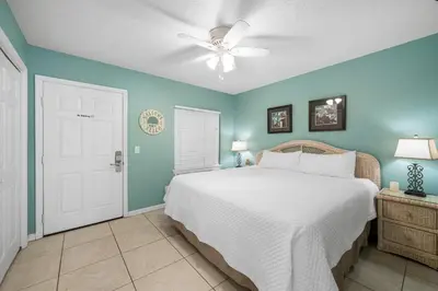a bedroom with a bed and a ceiling fan at Merrimac Resort #12 in Panama City Beach