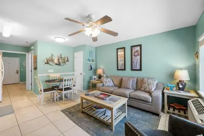 a living room with a couch and a table at Merrimac Resort #12 in Panama City Beach