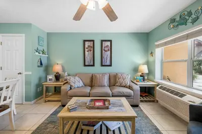 a living room with a couch and a table at Merrimac Resort #12 in Panama City Beach