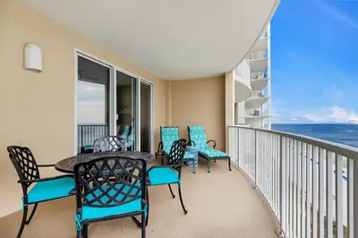 a balcony with a table and chairs and the ocean at Ocean Villa 1605 in Panama City Beach