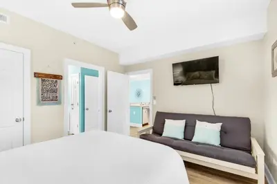 a bedroom with a bed and a couch at Ocean Villa 1605 in Panama City Beach