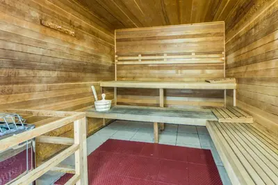 a sauna with wooden walls and wooden shelves at Ocean Villa 1605 in Panama City Beach