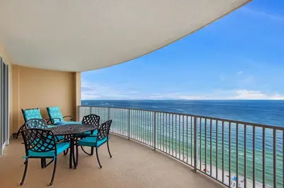 a balcony with a table and chairs and the ocean at Ocean Villa 1605 in Panama City Beach