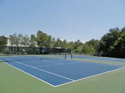 a tennis court with two tennis nets on it at Cassine Station 305 - Sea Ya in Santa Rosa Beach