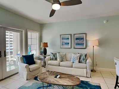 a living room with a couch and a table at Cassine Station 305 - Sea Ya in Santa Rosa Beach