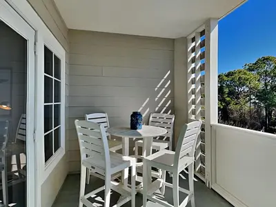 a table and chairs on the porch of a house at Cassine Station 305 - Sea Ya in Santa Rosa Beach