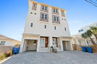 a large white building with a driveway in front at Beach House - Sugar Sands by Panhandle Getaways in Panama City Beach