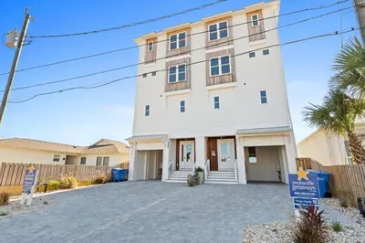 a large white building with a driveway at Beach House - Sugar Sands by Panhandle Getaways in Panama City Beach
