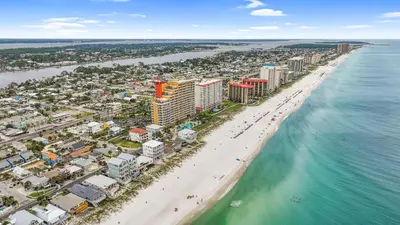 an aerial view of a beach with buildings and the ocean at Beach House - Sugar Sands by Panhandle Getaways in Panama City Beach