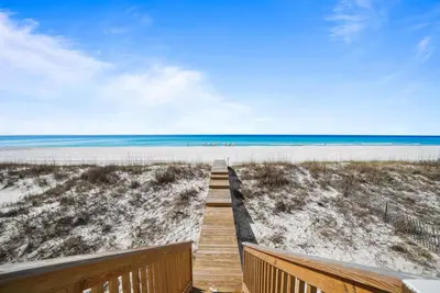 a boardwalk to the beach with the ocean in the background at Beach House - Sugar Sands by Panhandle Getaways in Panama City Beach