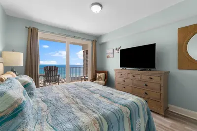 a bedroom with a bed and a flat screen tv at Coast is Clear at Laketown Wharf #1225 by Nautical Properties in Panama City Beach