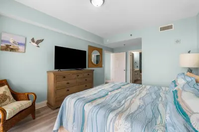 a bedroom with a bed and a flat screen tv at Coast is Clear at Laketown Wharf #1225 by Nautical Properties in Panama City Beach