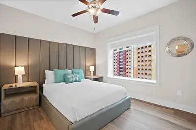 a bedroom with a bed and a ceiling fan at Calypso 3-1601 - Corine's Corner in Panama City Beach