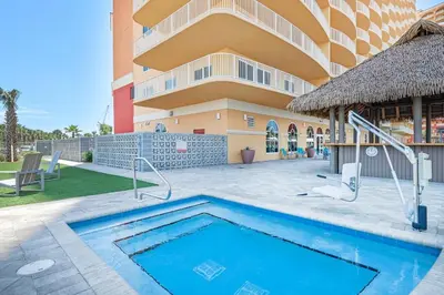 a swimming pool in front of a building at Calypso 3-1601 - Corine's Corner in Panama City Beach