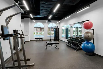 a gym with cardio equipment in a room with windows at Calypso 3-1601 - Corine's Corner in Panama City Beach