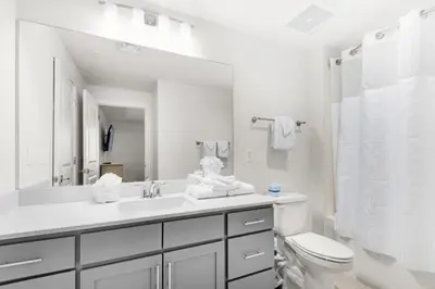 a white bathroom with a sink and a toilet at Calypso 3-1511 in Panama City Beach