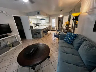 a living room with a couch and a table at Sea & sand in Panama City Beach