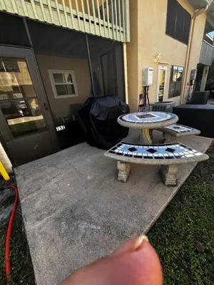 a person pointing at a table in front of a building at Sea & sand in Panama City Beach