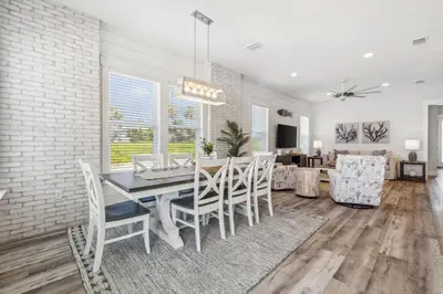 a dining room with a table and chairs at Laguna Beach Pearl by InJoy Vacations in Panama City Beach