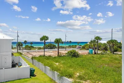 a view of the ocean from the balcony of a house at Laguna Beach Pearl by InJoy Vacations in Panama City Beach