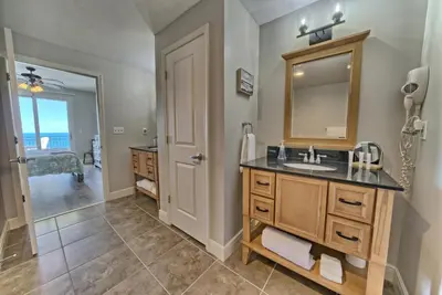 a bathroom with a sink and a mirror at OCEAN FRONT CONDO w INCREDIBLE VIEWS in Panama City Beach