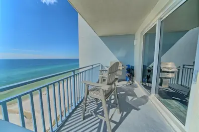 a balcony with a chair and the ocean at OCEAN FRONT CONDO w INCREDIBLE VIEWS in Panama City Beach