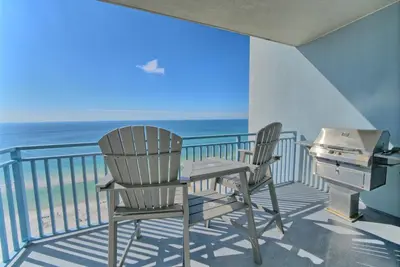 two chairs and a desk on a balcony with the ocean at OCEAN FRONT CONDO w INCREDIBLE VIEWS in Panama City Beach