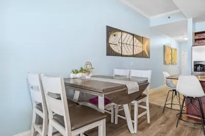 a dining room with a table and chairs at Penthouse Perfection at Laketown Wharf #2127 by Nautical Properties in Panama City Beach