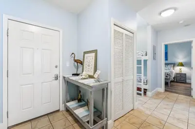 a hallway with a white door and a desk in a room at Penthouse Perfection at Laketown Wharf #2127 by Nautical Properties in Panama City Beach