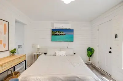 a white bedroom with a large bed in it at The Coastal Cabana in Panama City Beach