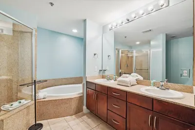 a bathroom with two sinks and a shower at The Beach Scene at Laketown Wharf #524 by Nautical Properties in Panama City Beach