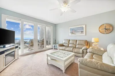 a living room with a couch and a tv at The Beach Scene at Laketown Wharf #524 by Nautical Properties in Panama City Beach