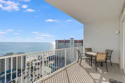 a balcony with a table and chairs and the ocean at Laketown Wharf 2018 in Panama City Beach