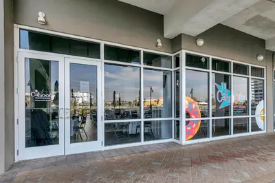a restaurant with glass doors and a view of the city at Laketown Wharf 2018 in Panama City Beach
