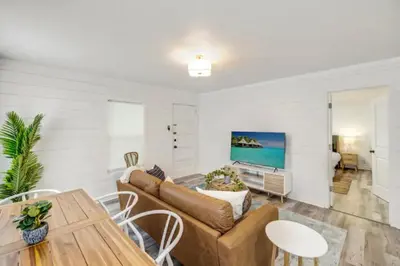 a living room with a couch and a table at The Coastal Shanty, yards from the beach in Panama City Beach