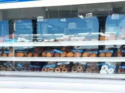 a bunch of donuts are in a display window at The Coastal Shanty, yards from the beach in Panama City Beach