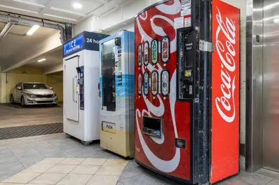 two coca cola machines in a garage with a car at Slice o’ Paradise - Gulf Front! Walk to Pier Park in Panama City Beach