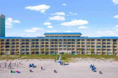 a large hotel on the beach with people on the beach at Slice o’ Paradise - Gulf Front! Walk to Pier Park in Panama City Beach