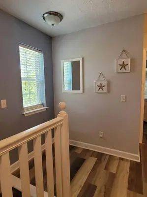 a room with a staircase and two windows at McDrifty's Getaway in Panama City Beach