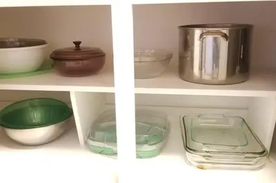 a shelf filled with bowls and other kitchen items at McDrifty's Hideaway in Panama City Beach