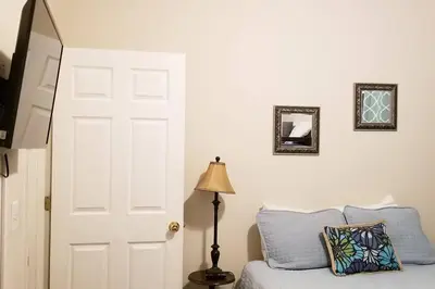 a bedroom with a bed and a white door and a lamp at McDrifty's Hideaway in Panama City Beach